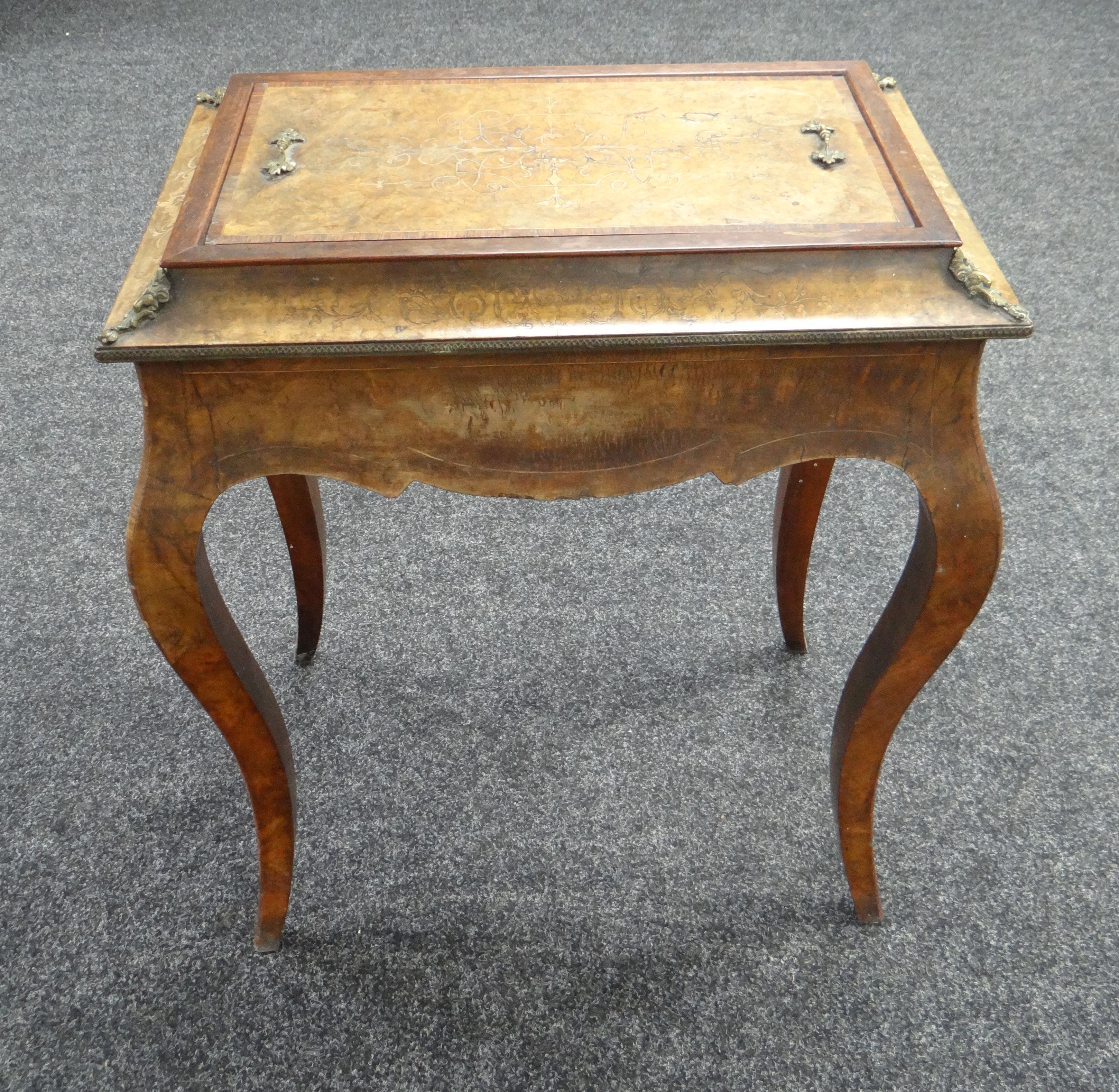 A NINETEENTH CENTURY MARQUETRY WALNUT SEWING TABLE with ormolu fittings and on shaped legs (