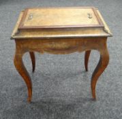 A NINETEENTH CENTURY MARQUETRY WALNUT SEWING TABLE with ormolu fittings and on shaped legs (