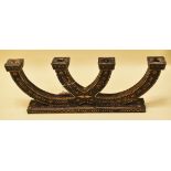 A PAINTED WOODEN FOUR BRANCH CANDLE HOLDER on a wide rectangular base and decorated in straw work,