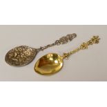 A CONTINENTAL SILVER-GILT SPOON with twist-stem and figural handle and another, 1.8ozs