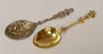 A CONTINENTAL SILVER-GILT SPOON with twist-stem and figural handle and another, 1.8ozs