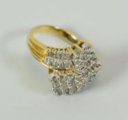 A MODERN MULTI-DIAMOND RING IN 18CT YELLOW GOLD set with many baguette and round cut diamonds in a