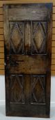 A BELIEVED SEVENTEENTH CENTURY FRENCH PANELLED WOODEN DOOR 74cms wide, 180cms high