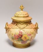 A ROYAL WORCESTER PORCELAIN BLUSH VASE of ornate moulded form with twin-handles and finial picked
