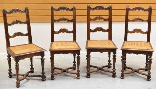 A SET OF FOUR FRENCH CANE WORK CHAIRS having carved ladder backs, carved supports, X-stretcher and