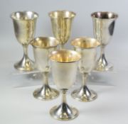 A SET OF SIX AMERICAN SILVER GOBLETS of plain undercorated form raised over spreading feet,