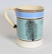 A 19TH CENTURY HALF PINT MOCHA WARE MUG, with sponged foliate decoration and banding, 12.5cms high