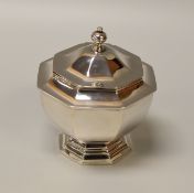 A SILVER SUCRIER of faceted form with hinged lid, Thomas Bradbury & Sons, London 1906, 9.45ozs