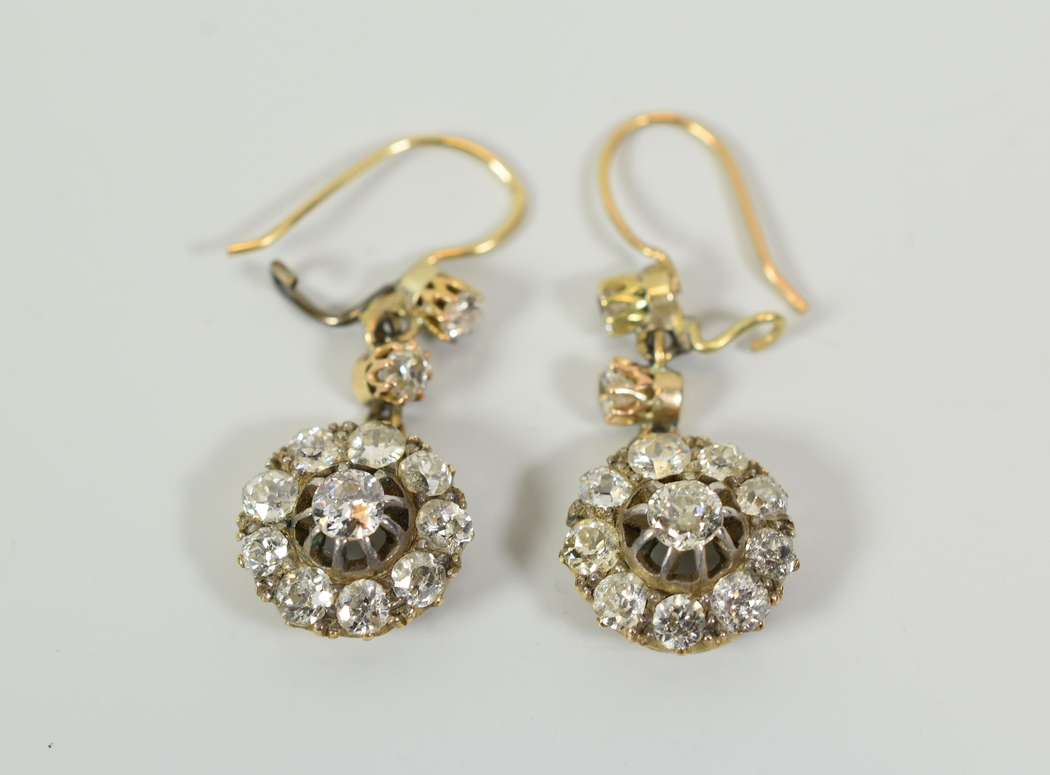 A GOOD PAIR OF ANTIQUE DIAMOND CLUSTER EARRINGS each cluster composed of ten round brilliant cut