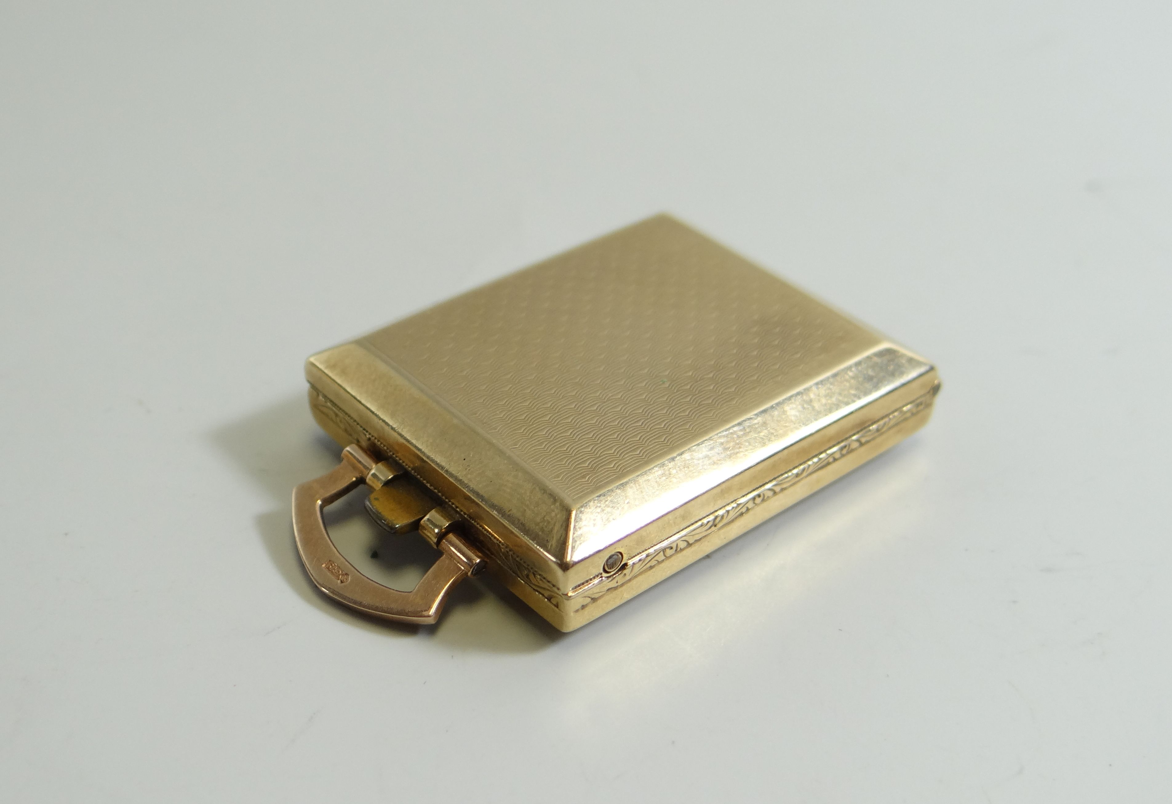 A 9CT YELLOW GOLD FOLDING MINIATURE TRAVEL CLOCK, having a machine-turned outer-case and with square - Image 2 of 2