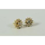 A PAIR OF PRETTY FLORAL DIAMOND EARRINGS the centre diamonds approx 0.25ct each in 18ct yellow gold