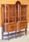 A FINE QUALITY INLAID MAHOGANY DISPLAY CABINET having a cupboard base raised over a platform and