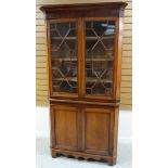 A TWO-DOOR MAHOGANY CORNER CABINET composed of base cupboard and top with astragal glazing and