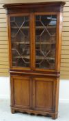 A TWO-DOOR MAHOGANY CORNER CABINET composed of base cupboard and top with astragal glazing and