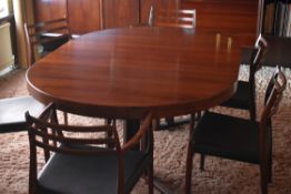 A DANISH ROSEWOOD EXTENDING OVAL DINING TABLE and four + two chairs, 127cms wide