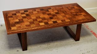 A DANISH-STYLE ROSEWOOD LONG JOHN COFFEE TABLE having a chequered top and rectangular joined