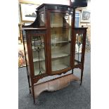 A GOOD EDWARDIAN MAHOGANY STANDING CABINET raised over a shaped base and with full length convex