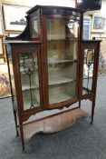 A GOOD EDWARDIAN MAHOGANY STANDING CABINET raised over a shaped base and with full length convex