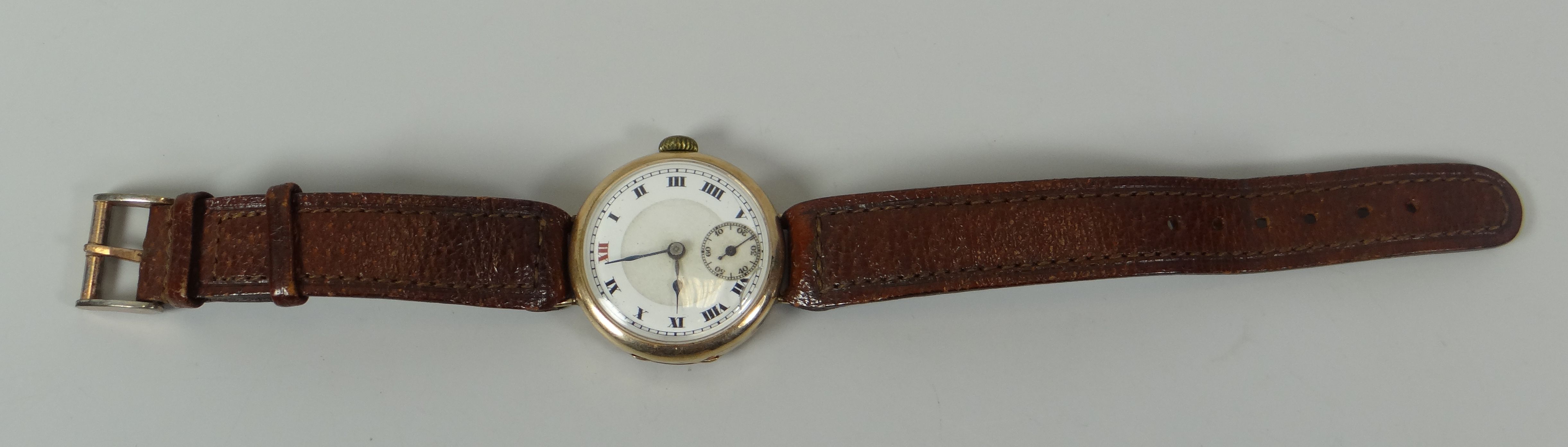 A VINTAGE 9CT GOLD ENCASED WRISTWATCH on later tan leather strap, the dial with Roman numerals and