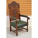 A WELSH EISTEDDFOD CHAIR carved with a dragon to the back and with leek and daffodil above,