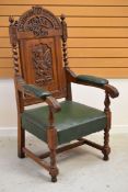 A WELSH EISTEDDFOD CHAIR carved with a dragon to the back and with leek and daffodil above,