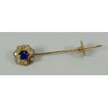 A BELIEVED 18CT GOLD DIAMOND & SAPPHIRE TIE-PIN composed of centre sapphire and seven outer old-mine