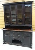 A STAINED OAK EDWARDIAN DRESSER composed of a base with dog kennel, three drawers and flanking