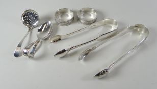 A PARCEL OF SILVER comprising two pairs of sugar tongs, a pair of napkin rings and two small spoons,
