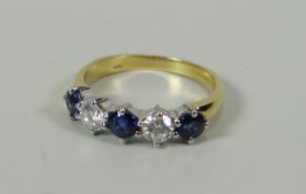 A GOOD DIAMOND & SAPPHIRE RING IN 18CT YELLOW GOLD composed of a row of three sapphires