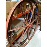 A PAIR OF FRENCH PAINTED IRON CARTWHEELS having seven spokes and raised lettering on the hubs,