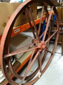 A PAIR OF FRENCH PAINTED IRON CARTWHEELS having seven spokes and raised lettering on the hubs,