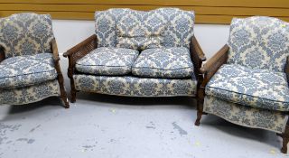 A THREE-PIECE BERGERE SUITE comprising two-seater settee with reeded and carved arms, two matching