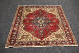 AN OLD RED GROUND PERSIAN TABRIZ RUG 195 x 137cms