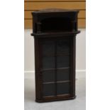 A CONTINENTAL HANGING CORNER CABINET with single glazed door, 92 x 55cms