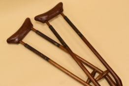 A PAIR OF MAHOGANY, BRASS & LEATHER CRUTCHES circa 1910-1920