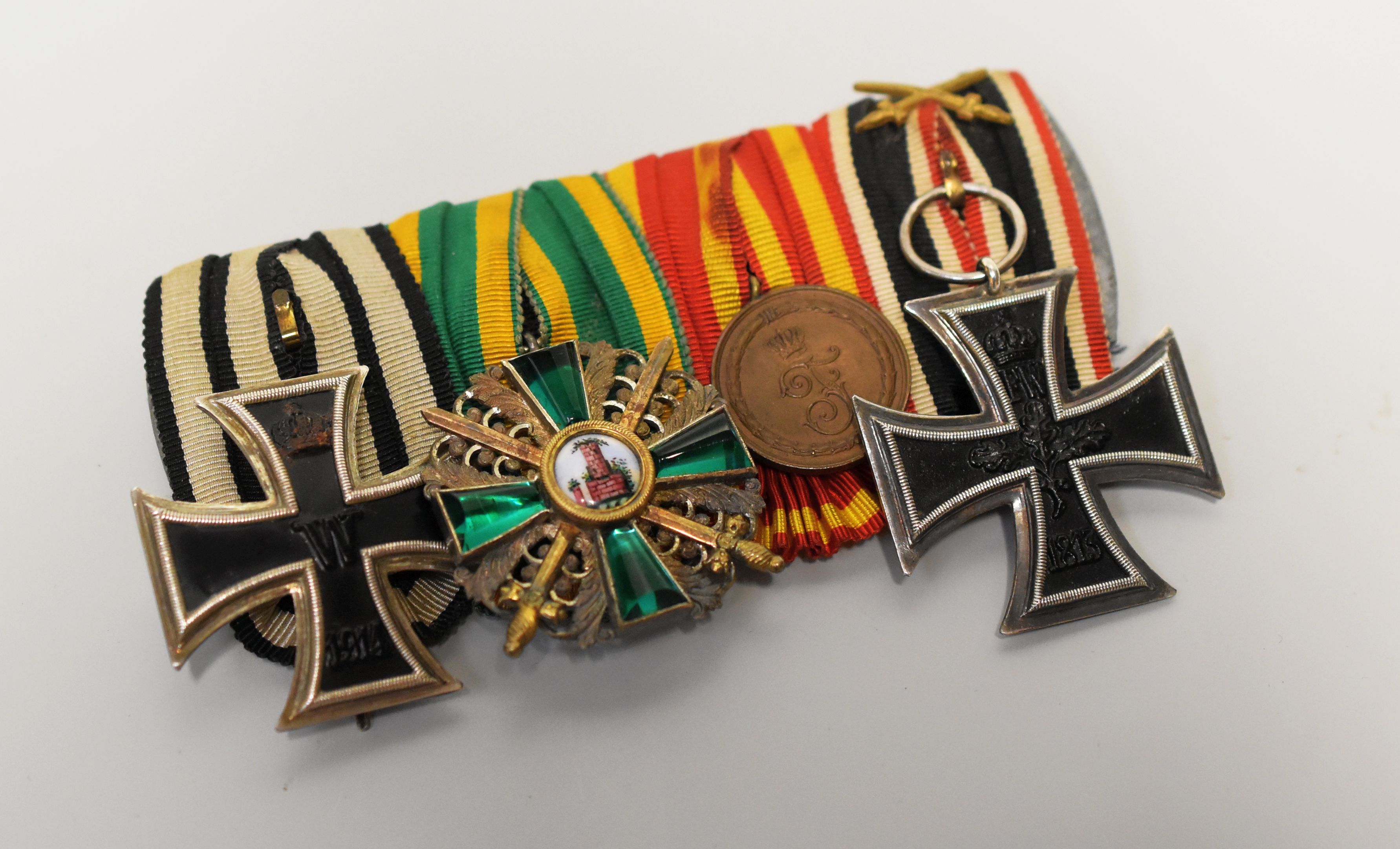 A GERMAN WWI FOUR MEDAL GROUP WITH RIBBONS comprising long service medal ('fur treue dienste