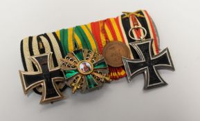 A GERMAN WWI FOUR MEDAL GROUP WITH RIBBONS comprising long service medal ('fur treue dienste