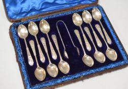 A CASED SET OF SILVER TEASPOONS & TONGS with decorative and monogrammed handles, Sheffield 1899, 5.