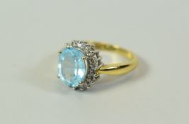 A DIAMOND & AQUAMARINE RING in 18ct yellow gold, 4.7gms