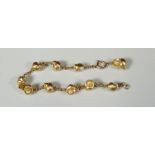 A 9CT GOLD CHAIN BRACELET OF INTERSPERSED SHELLS with each shell set with a natural pearl, marked '
