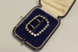 A NINETEENTH CENTURY ROUNDED RECTANGULAR BUCKLE set with twenty-two black-dot paste stones, 38cms