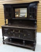 A TURN OF THE CENTURY STAINED MAHOGANY MIRROR BACK SIDEBOARD raised on platform base with two centre