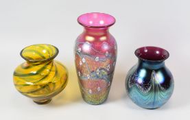 THREE ITEMS OF ART GLASS comprising Caithness swirl effect vase and two Okra vases