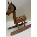 A HOMEMADE WOODEN ROCKING CHAIR, probably mid-twentieth century, with barrel body and wool mane