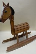 A HOMEMADE WOODEN ROCKING CHAIR, probably mid-twentieth century, with barrel body and wool mane