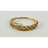 A 9CT GOLD BANGLE of openwork design with a rope twist and a series of spheres to the centre, 14gms