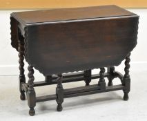 A STAINED BARLEY-TWIST DROP LEAF GATE LEG TABLE