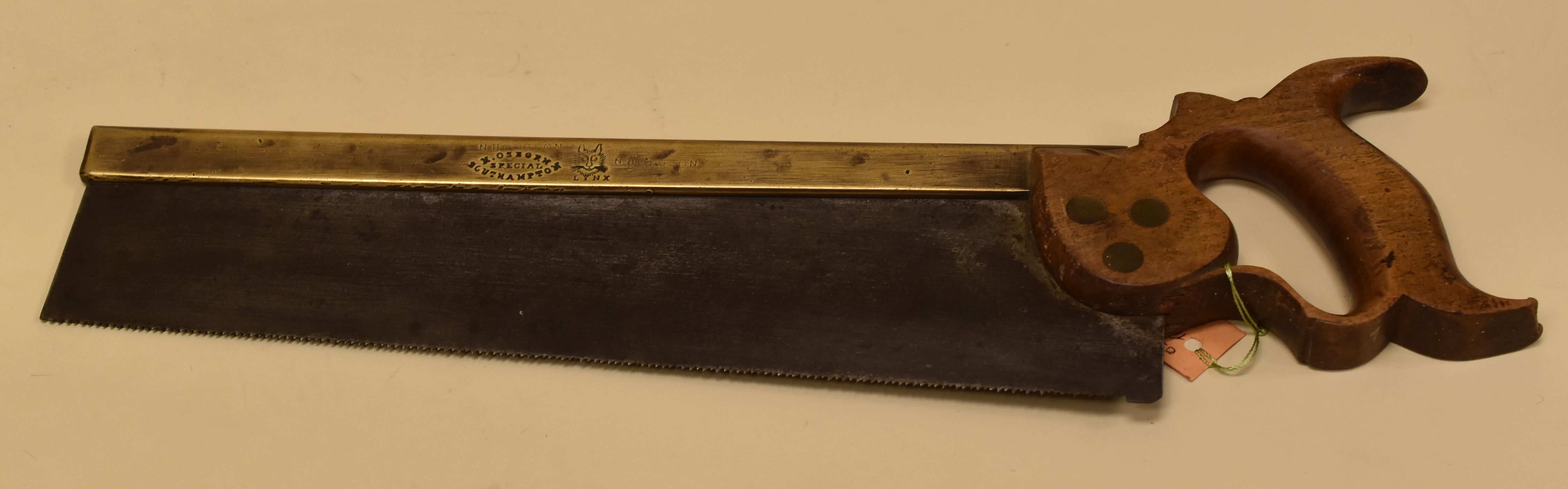 A VICTORIAN ENGLISH 'LYNX' TENON SAW having a curly beech wood handle, milled brass back and