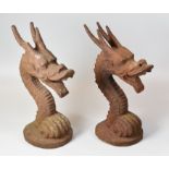 A PAIR OF IRON WORK GATEPOST HEADS in the form of serpent creature heads, 34cms high