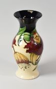 A 1998 MOORCROFT VASE in two tone reserve with tube-lined orchids, 19cms high